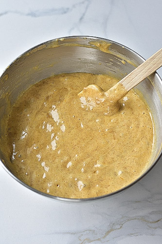 apple walnut cake batter in a metal bowl