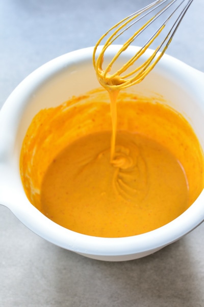 pumpkin pie apple ring pancake batter in a white bowl