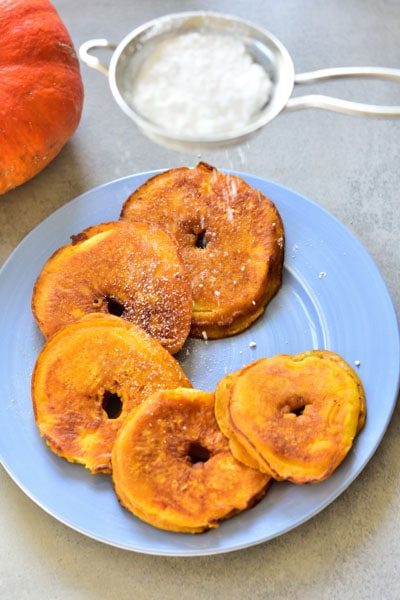 pumpkin pie apple rin pancakes are being sprinkled with powdered sugar