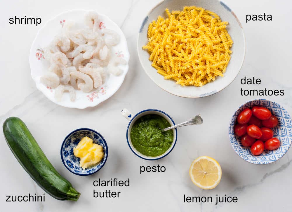 Labeled ingredients needed to prepare shrimp pesto pasta.