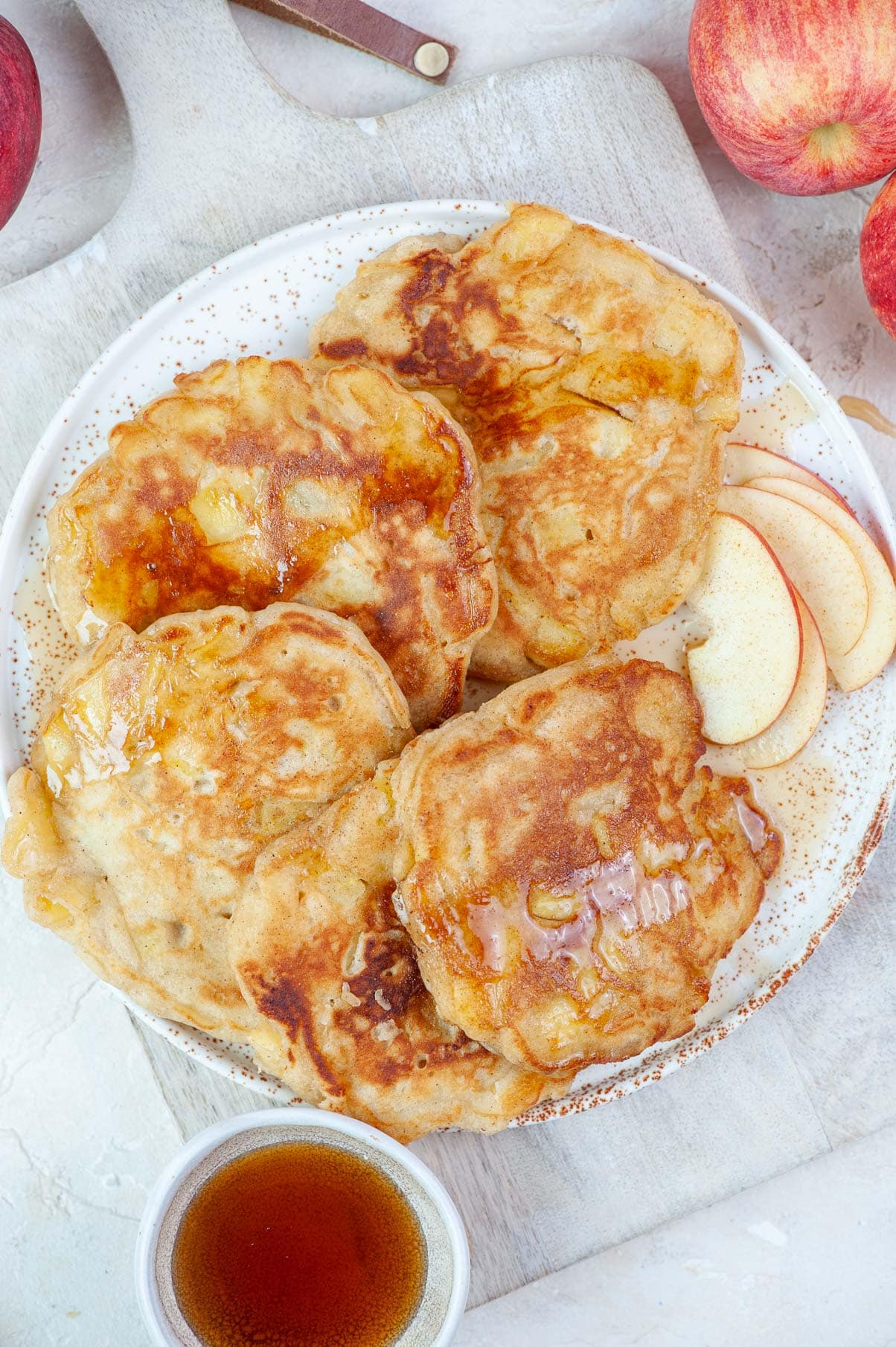 Apple cinnamon pancakes on a white plate.