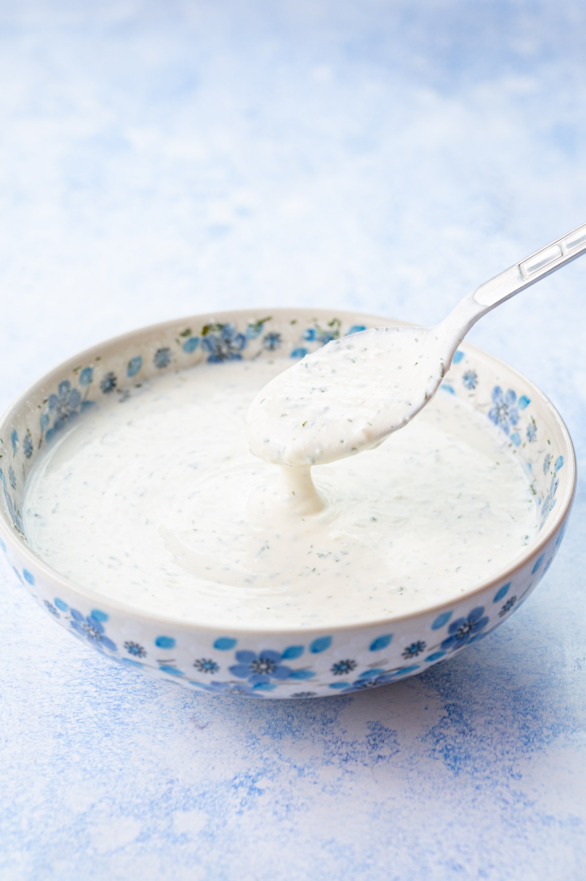 Ranch dressing in a white-blue bowl.