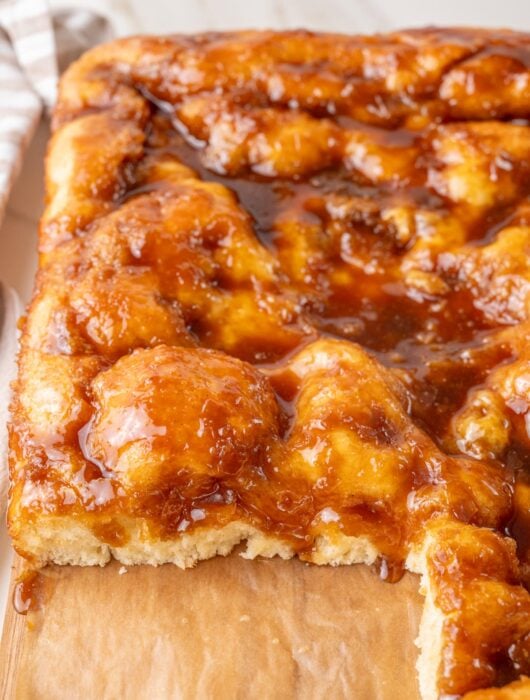 A close-up photo of Brunsviger cake on a wooden board.