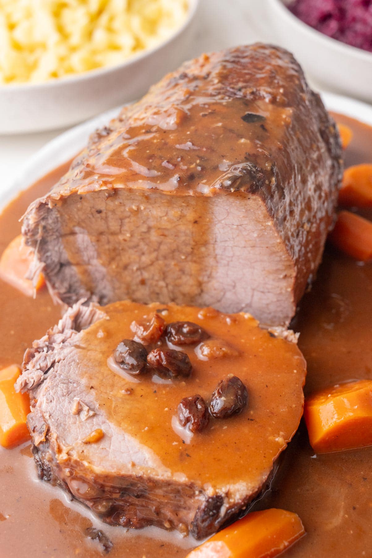 Sauerbraten roast with a slice cut of as a brown sause with raisins.